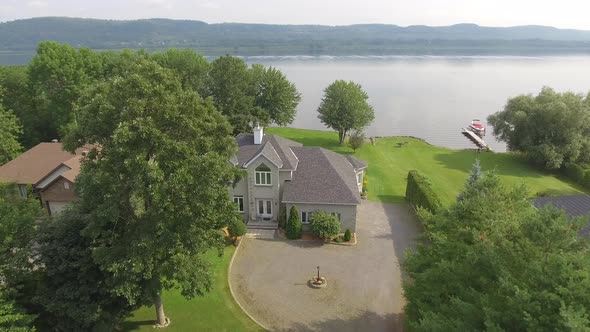 real estate aerial waterfront home fly overe low 4k