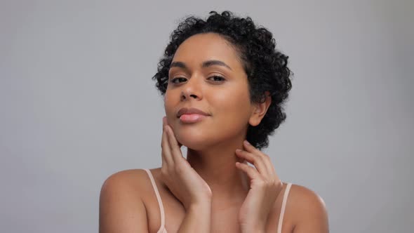 Portrait of Young Woman Touching Her Face