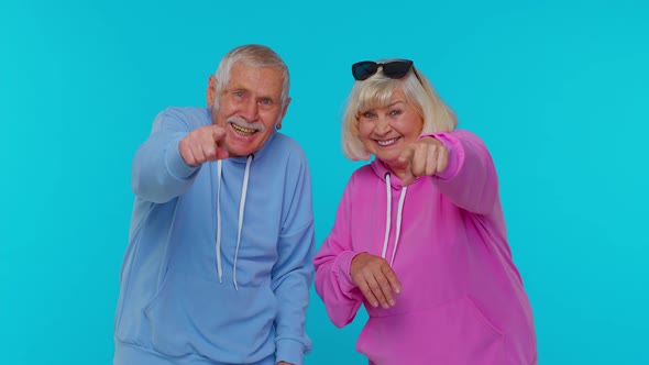 Amused Senior Couple Man Woman Grandparents Pointing Finger to Camera Laughing Out Loud Funny Joke