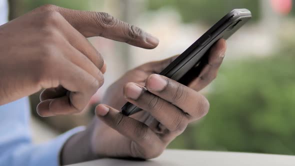 African Hand Using Smartphone