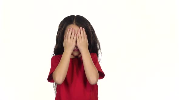Little Female Covers Her Face with Hands. Slow Motion
