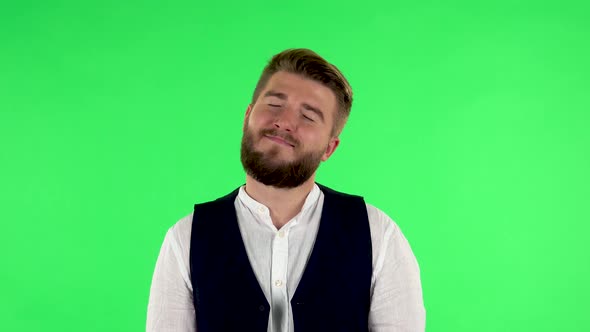 Man Daydreaming and Smiling Looking Up Against Green Screen