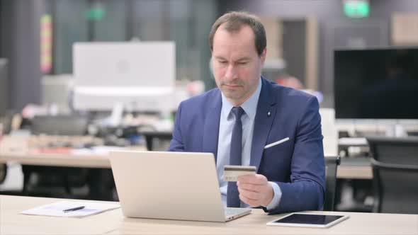 Businessman Making Successful Online Payment on Laptop