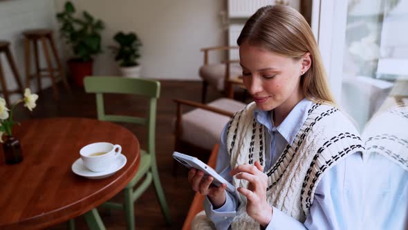 Positive blonde woman leafing tape by phone