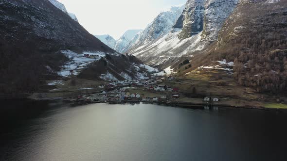 Distant panoramic aerial overview of Undredal village seen from seaside with mountains and valley in