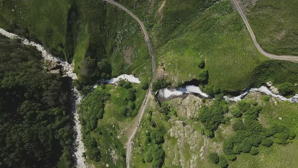 Drone View of a Powerful Stream of a Mountain Waterfall on a Sunny Summer Day