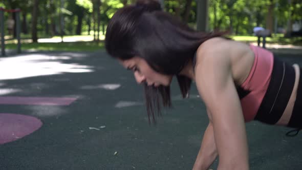 Young Active Woman Doing Fitness and Pushups on the Outdoor Sports Ground