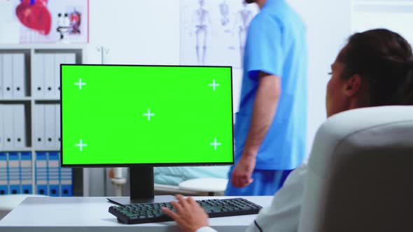 Doctor Working on Computer with Green Screen