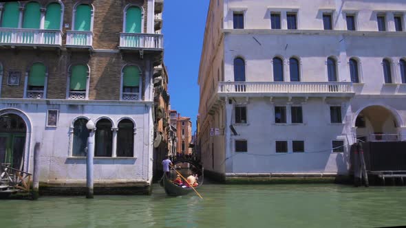 Tourists Sailing on Gondola, Boat Tour Along Grand Canal in Venice, Italy Sights