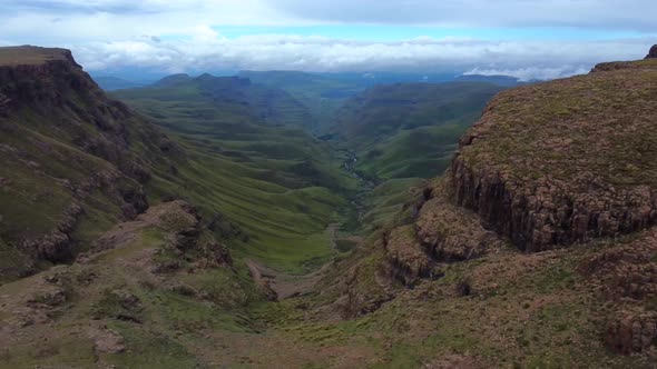 Drone shot of Drakensberg in South Africa - drone is on top of the mountain and revealing Sani Pass
