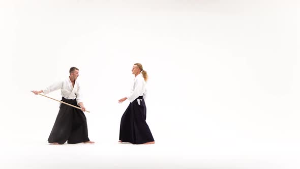 Two Fellows in Kimono Performing Aikido Using Bokken