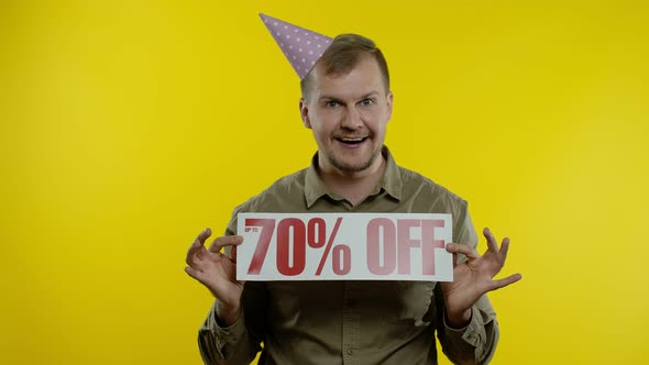 Joyful Man Showing Sale Word and Showing Up To 70 Percent Off Inscription. Black Friday Concept