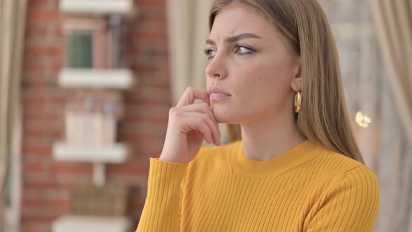 Portrait of Beautiful Young Woman Thinking About Something