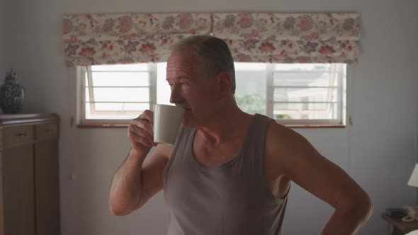 Senior man drinking coffee at home