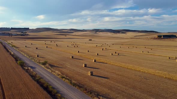 Straw bales at sunset seen from the air, drone view