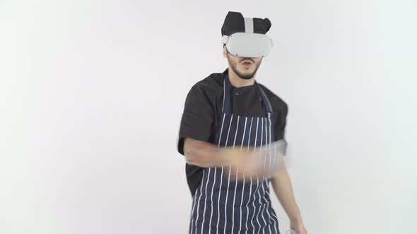 Young Man in Chef Uniform and Apron Playing Game with VR Glasses
