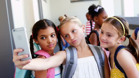 School kids taking selfie with mobile phone