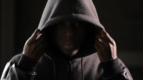 Man Wearing Hood in Darkness