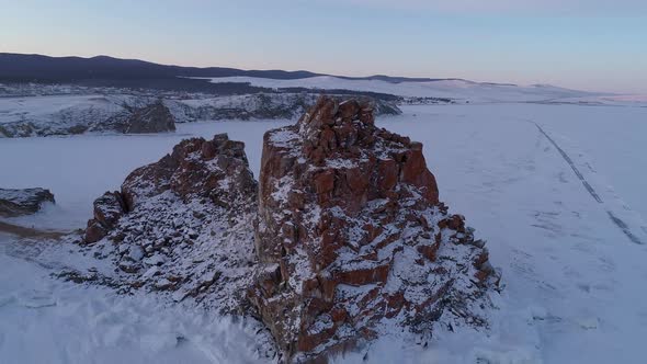 Aerial Orbital Shot of a Shamanka Rock on Olkhon Island at Sunset