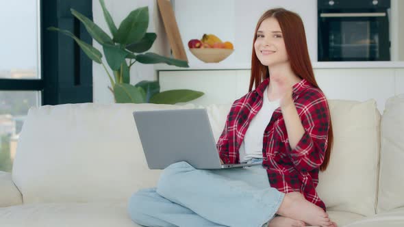 Successful Young Business Woman Freelancer Student Redhead Girl Works on Laptop at Home Communicate