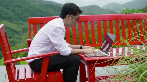 Man Working With A Laptop Outdoor