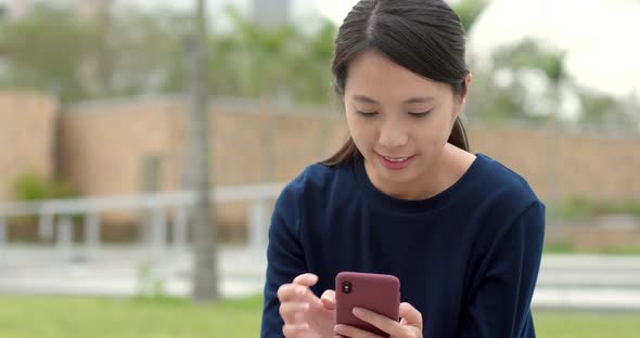 Woman use of mobile phone at outdoor park