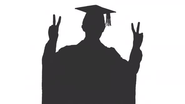 Black And White Silhouette Of Graduating Student In Gown Showing V Sign