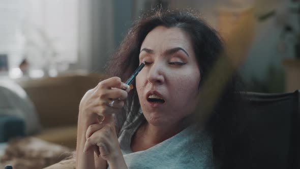 Woman with a Physical Disability Using Eyeliner