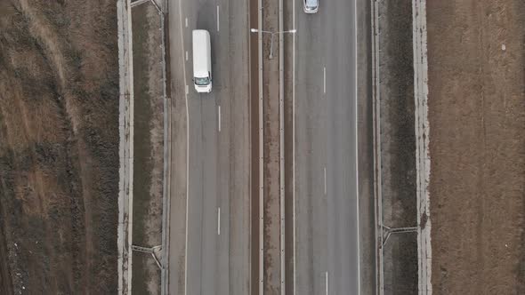 Aerial Top View of a Suburban Transport Road in Autumn or Winter Without Snow. Cars Drive