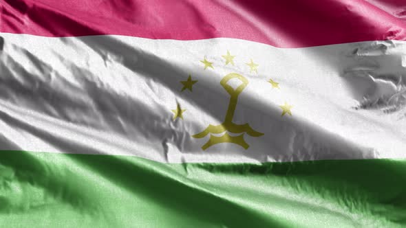 Tajikistan textile flag waving on the wind. Slow motion. 20 seconds loop.