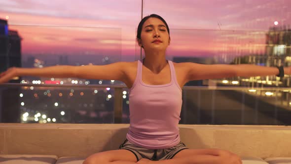 View of Young asian Woman Sitting on Mat and Practicing Yoga and Meditation