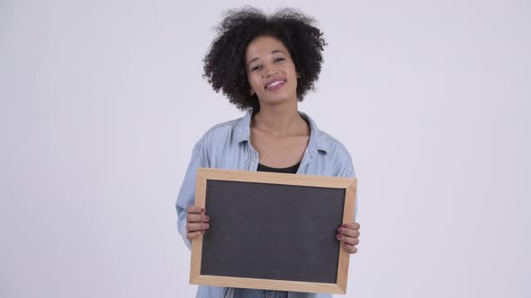 Young Happy African Woman Holding Blackboard
