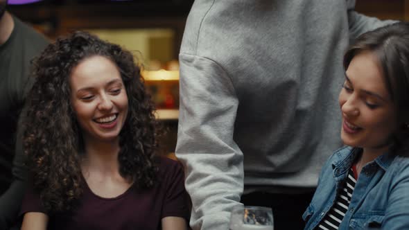 Two caucasian female friends meeting in the pub. Shot with RED helium camera in 8K.