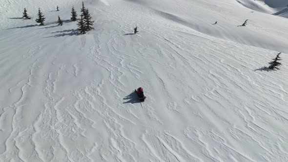 Snowmobile high in the mountains aerial view 4 K