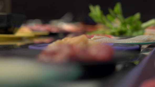 Food Conveyor. Asian Style Cafe with Food Moving on a Conveyor in a Little Plates. Concept of Food