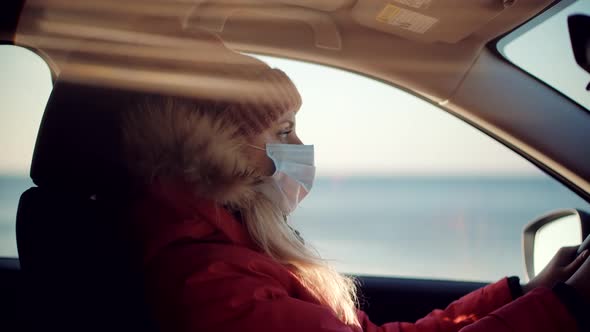 Woman Traveler Riding On Trip Holiday Vacation Adventure On Vehicle SUV. Female In Face Mask.