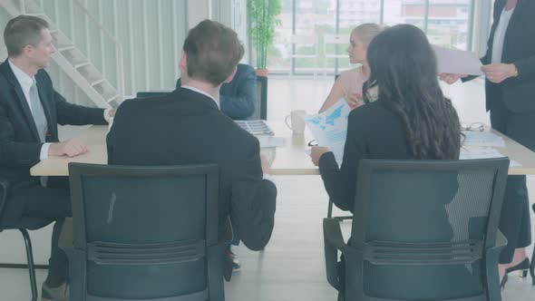 Group of business people presenting report statistics of financial with graph and chart.