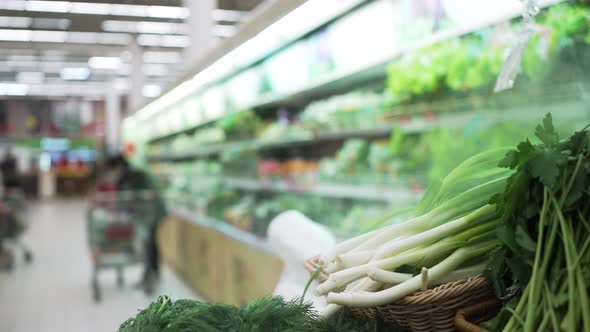 Dill and Green Onion on Shelf Near Fridge in Supermarket