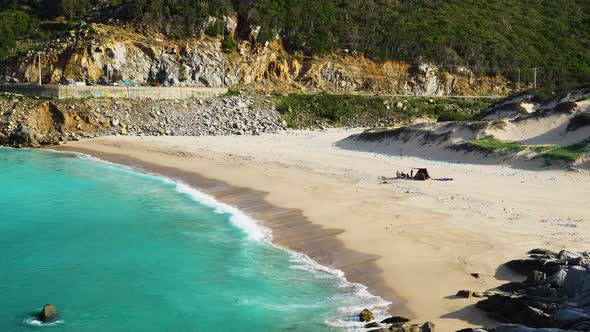 Pollution at Binh Hung beach with turquoise sea water breaking on shore. Vietnam