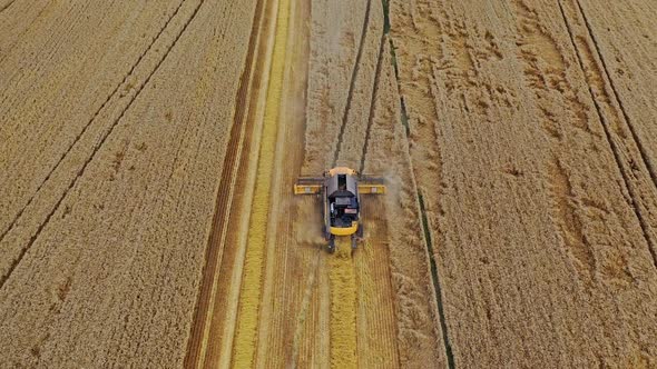 Modern combine harvester working on the field. View from above on the agricultural machine.