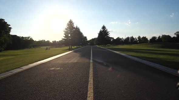 Happy LGBT Couple Leisurely Riding Bikes on Path