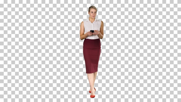 Woman typing write message on smart phone and walking