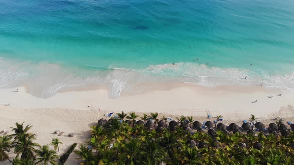 Drone View of a Tropical Beach with People Relaxing and Swimming