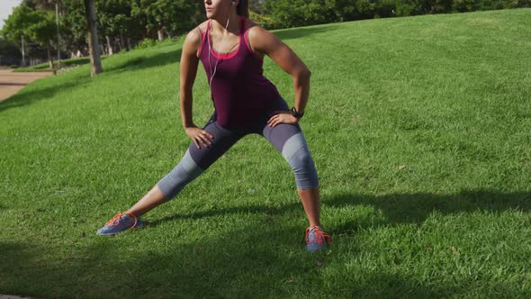 Caucasian woman stretching in a park