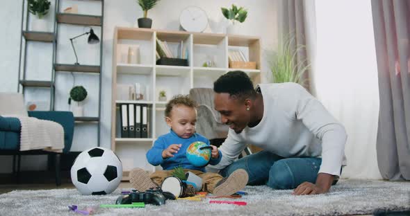 African American Dad Having Fun Together with His Cute Baby Boy at Home
