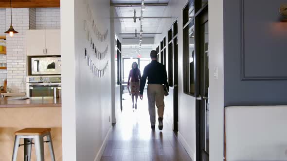 Business people walking in the corridor at office 4k