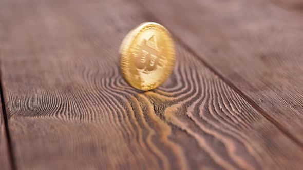 Bitcoin Coin Spinning on Wooden Background  Closeup with Slowmo