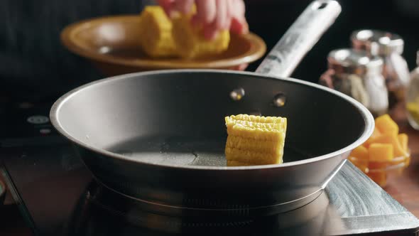 Chef Frying Corn in Pan Closeup
