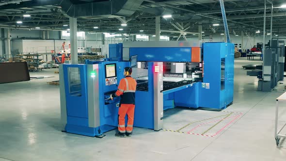 Refrigeration Factory Worker Is Controlling an Industrial Machine