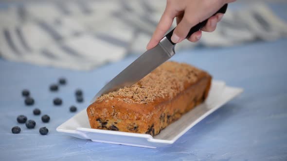 Cutting a Fresh Blueberry Crumble Pound Cake